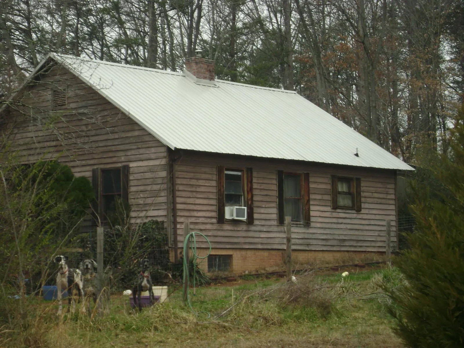 White metal roof on an old wood sided farmhouse, from a Metal Roof Installation job in Newbury